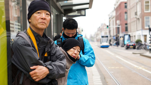 Man and son on street in city