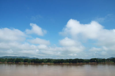 Scenic view of calm lake against cloudy sky