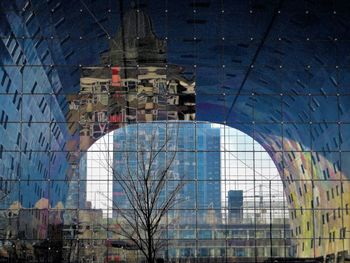 Low angle view of modern buildings against blue sky