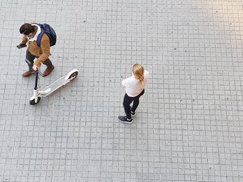 High angle view of couple walking on footpath