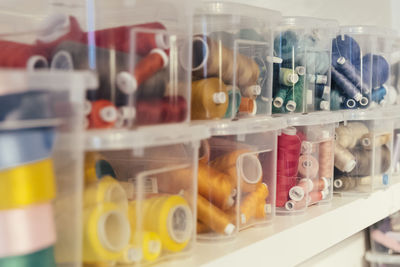 Close-up of multi colored bottles in shelf