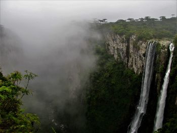 Scenic view of waterfall against sky