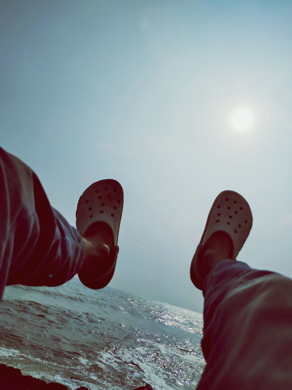 red, shoe, one person, human leg, low section, sky, personal perspective, limb, leisure activity, human limb, nature, lifestyles, adult, sports, men, footwear, water, day, human foot, winter, outdoors, sea, snow, standing, cold temperature, sunlight