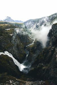 Scenic view of waterfall against sky