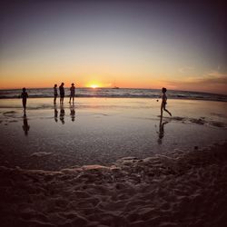 Silhouette of people on beach