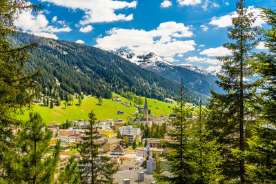 Scenic view of trees and mountains against sky