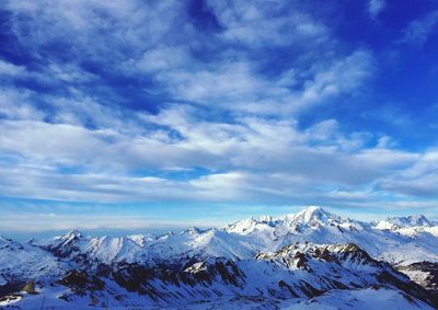 Scenic view of snowcapped mountains against sky