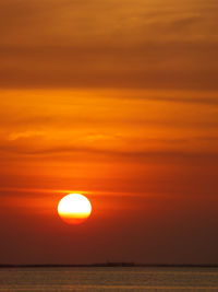 Scenic view of sea against orange sky