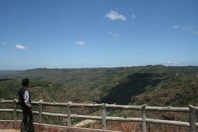 Rear view of a man on landscape against sky