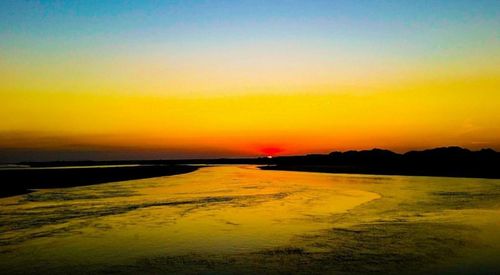 Scenic view of calm sea at sunset