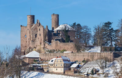 Houses in town against sky during winter