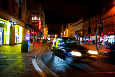 Illuminated city street at night