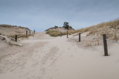 Scenic view of sand dunes against sky during winter