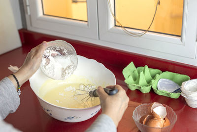 Midsection of woman holding ice cream in bowl