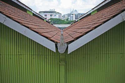 Metallic roof of building against sky