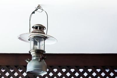 Low angle view of electric lamp against sky