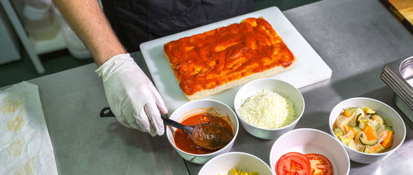 Cropped hand of person preparing food