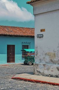 Road by building against sky