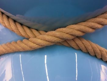 Close-up of rope on blue metal