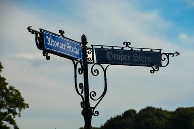 Low angle view of road sign against sky