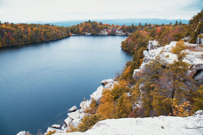 High angle view of lake by trees against sky