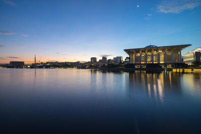 Tuanku mizan zainal abidin mosque by lake against sky