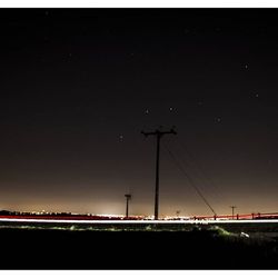 View of illuminated power lines