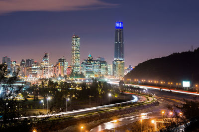 Illuminated cityscape against sky at night