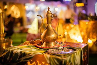 Close-up of illuminated lamp on table