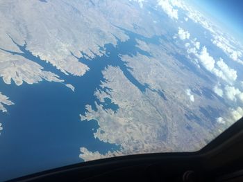 Aerial view of mountains seen through airplane window