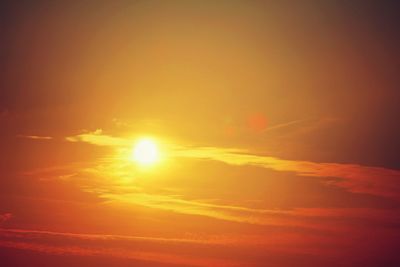 Sun shining through clouds at sunset