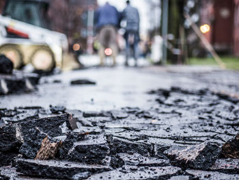 Close-up of wet road in city during winter