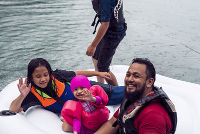 Portrait of happy family enjoying in water