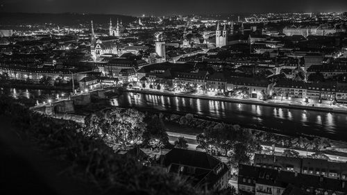 High angle view of city lit up at night