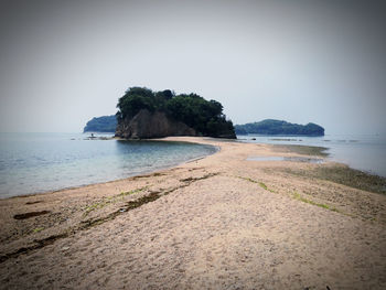 Scenic view of beach against clear sky