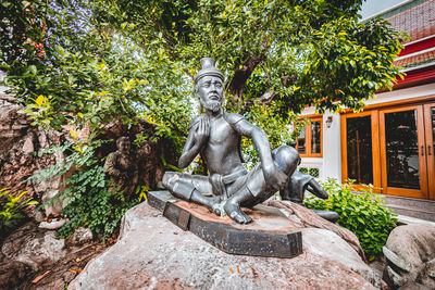 Low angle view of statue against trees