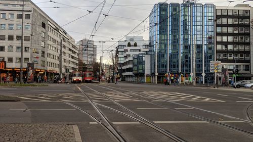 View of city street and buildings against sky
