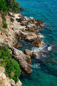 High angle view of rocks on sea