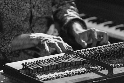 Midsection of man playing piano