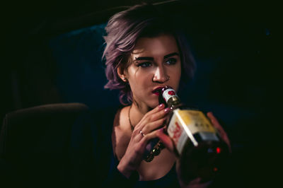 Close-up of woman drinking drink from bottle