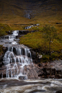Scenic view of waterfall against sky
