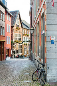 Bicycle parked by building in city