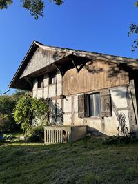 Abandoned building against clear blue sky