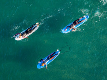 High angle view of people swimming in sea