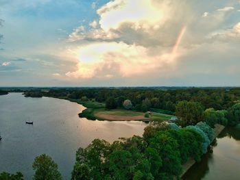 Scenic view of river against sky at sunset