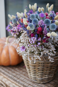 Close-up of flowers in wicker basket on table