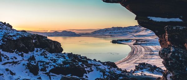 Scenic view of snowcapped mountains against sky during sunset