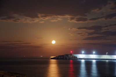 Scenic view of sea against sky during moon rise