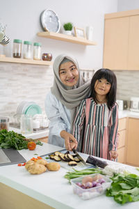 Portrait of woman with vegetables at home