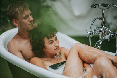 High angle view of man and woman in bathtub